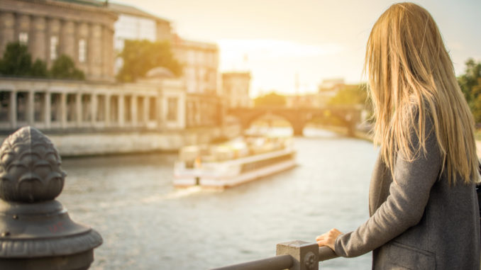 Rear view of a woman looking at the Spree river, Berlin.