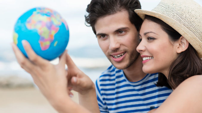 Excited young couple planning their holiday