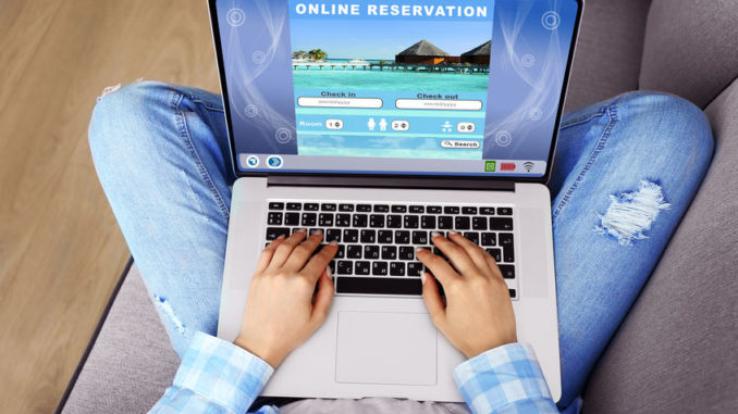 Woman using laptop to book hotel online