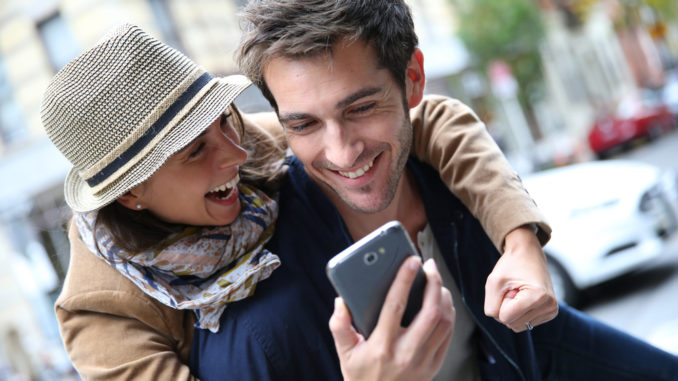 Cheerful,Couple,Having,Fun,Playing,With,Smartphone