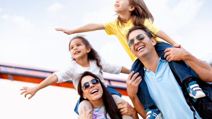 Happy,Family,Going,On,Holidays,And,Traveling,By,Airplane