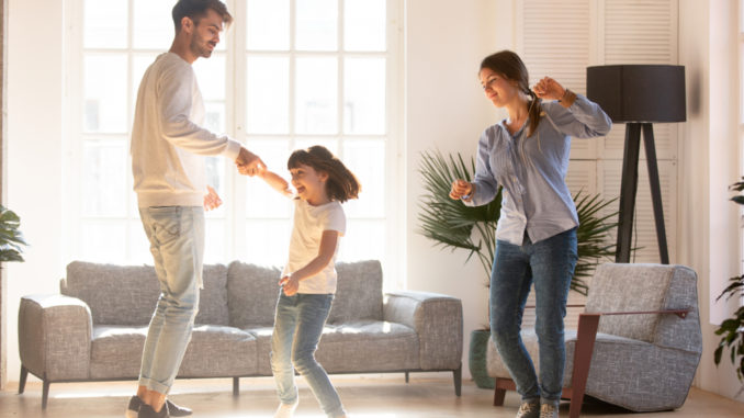 Family,Mother,Father,And,Preschool,Adorable,Daughter,In,Living,Room