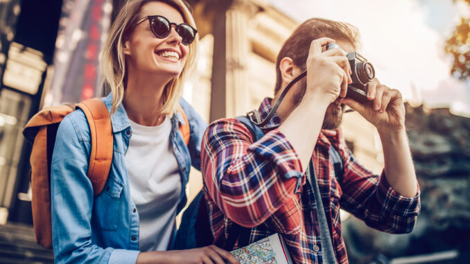 Couple,Of,Tourists,Is,Exploring,New,City,Together.,Smiling,And